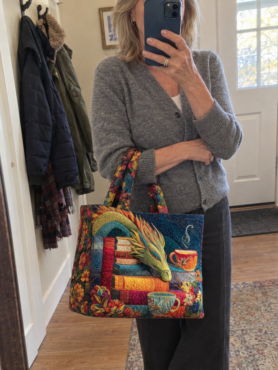 The Hollis dragon tote on Peggy's arm in the hallway mirror